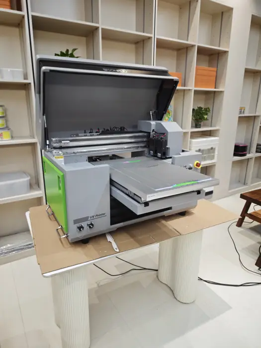 UV printing machine applying a custom logo to plastic parts
